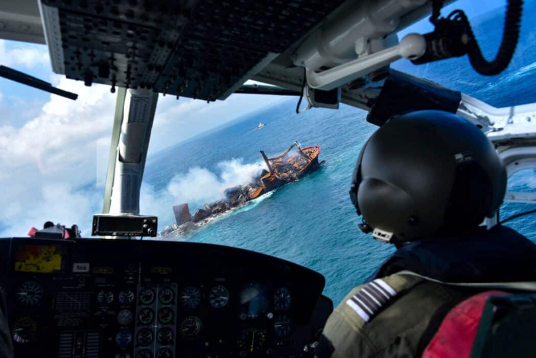 Helicopter Flying Over Ship Off The Coast Of Sri Lanka About To Sink