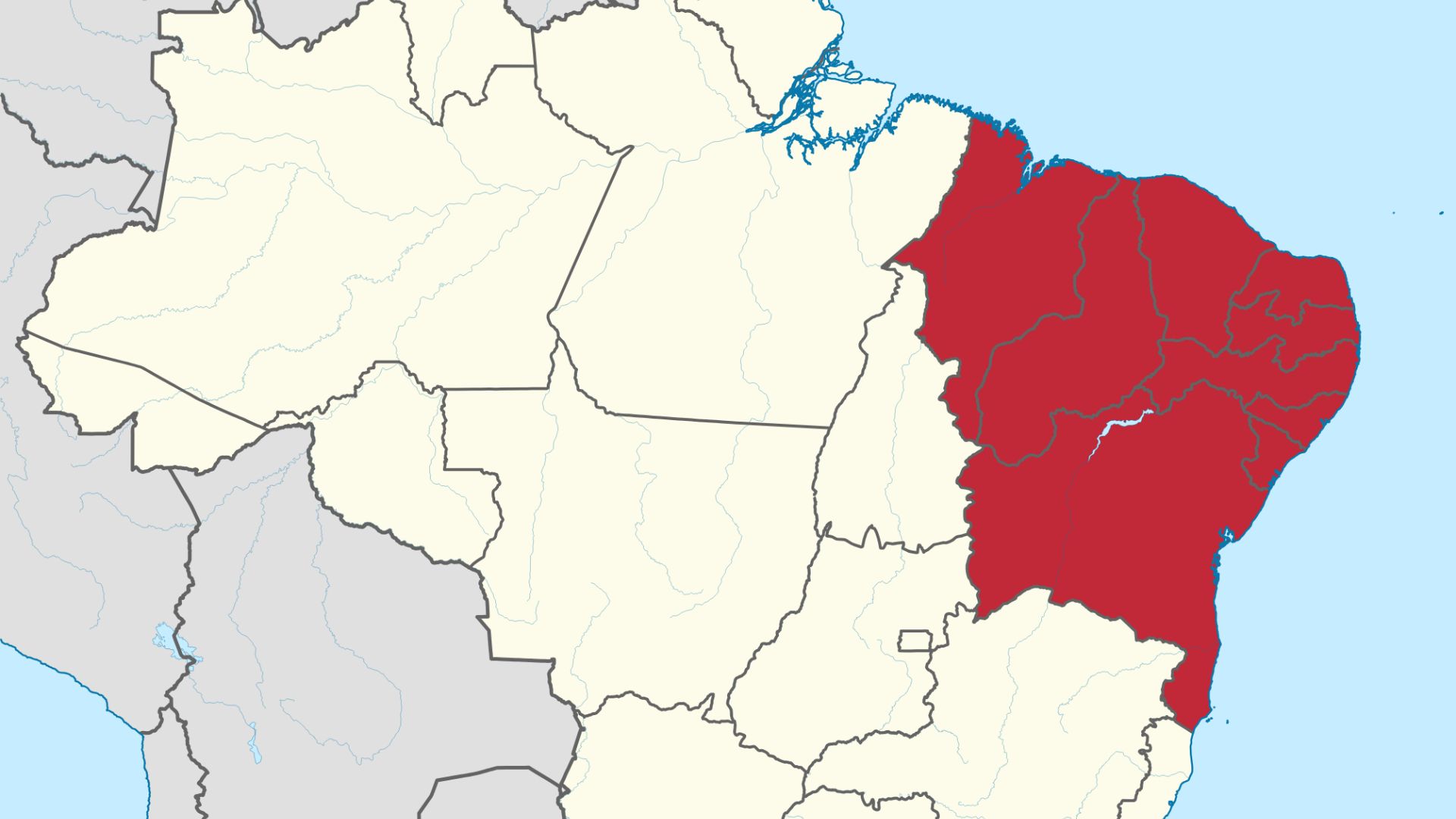 Bairro do Nordeste com presença de criminosos armados patrulhando ruas dominadas por facções.