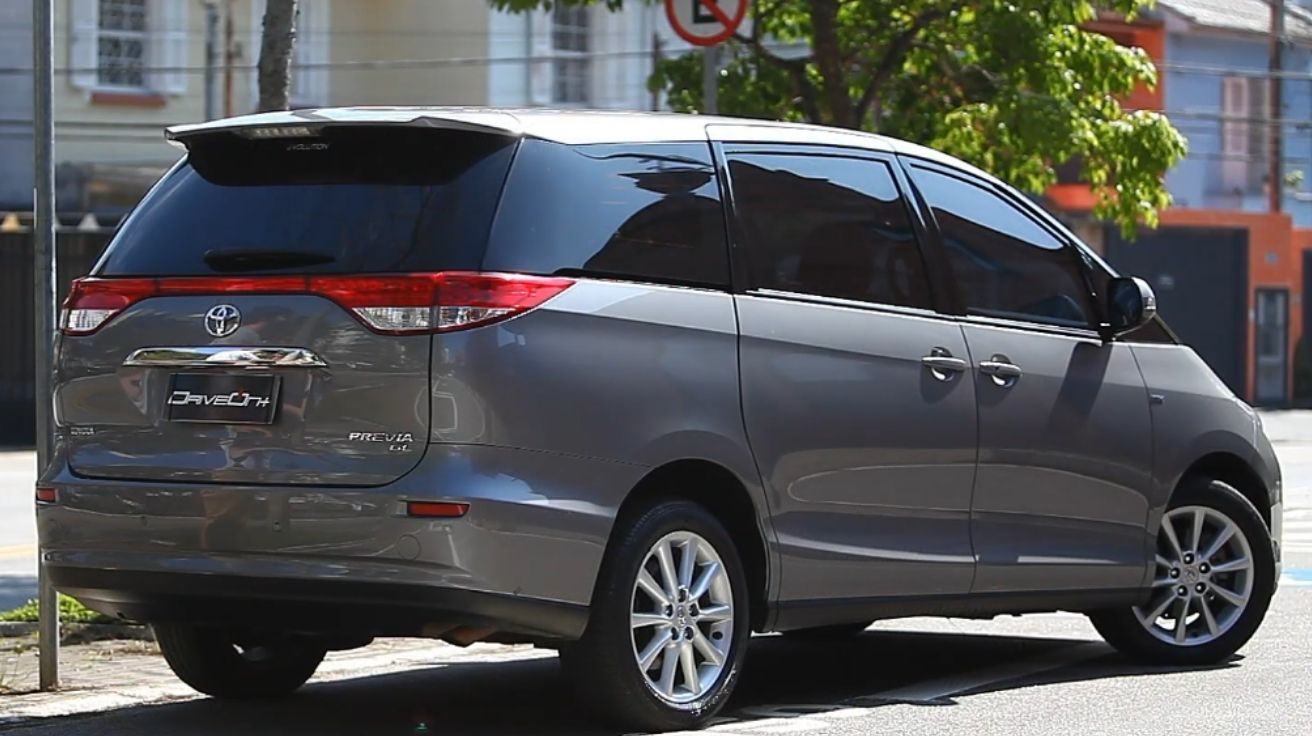 Traseira da minivan Toyota Previa GL 2018 blindada em cinza, com rodas aro 17 e vidros escurecidos, estacionada em rua de São Bernardo do Campo