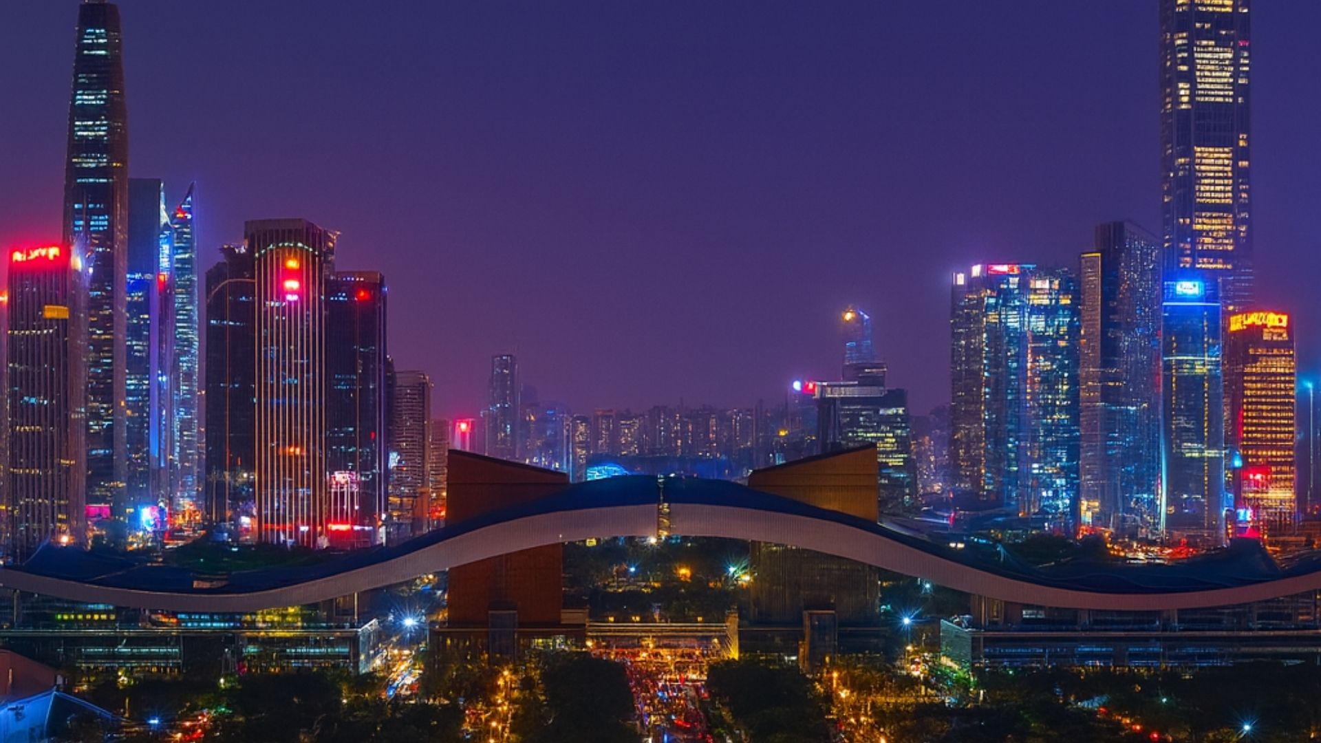 Fotografia realista em formato paisagem mostrando o distrito de Guiwan, em Shenzhen, China, com arranha-céus iluminados, ruas movimentadas e outdoors tecnológicos. A cena transmite prosperidade, riqueza e inovação, representando o rápido crescimento econômico da cidade. Estilo fotojornalismo contemporâneo, luz noturna vibrante e atmosfera de desenvolvimento urbano acelerado