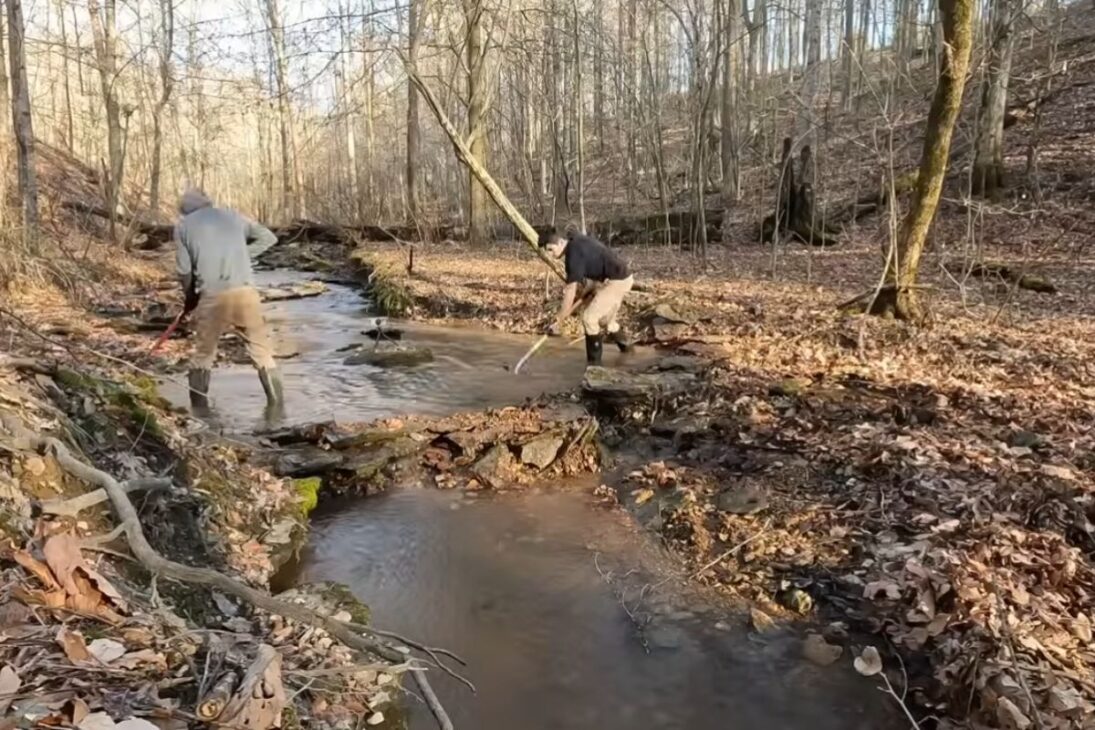 stone dam made in a stream tries to reduce erosion, lift water, and create a cool pool for use beside a future sauna.