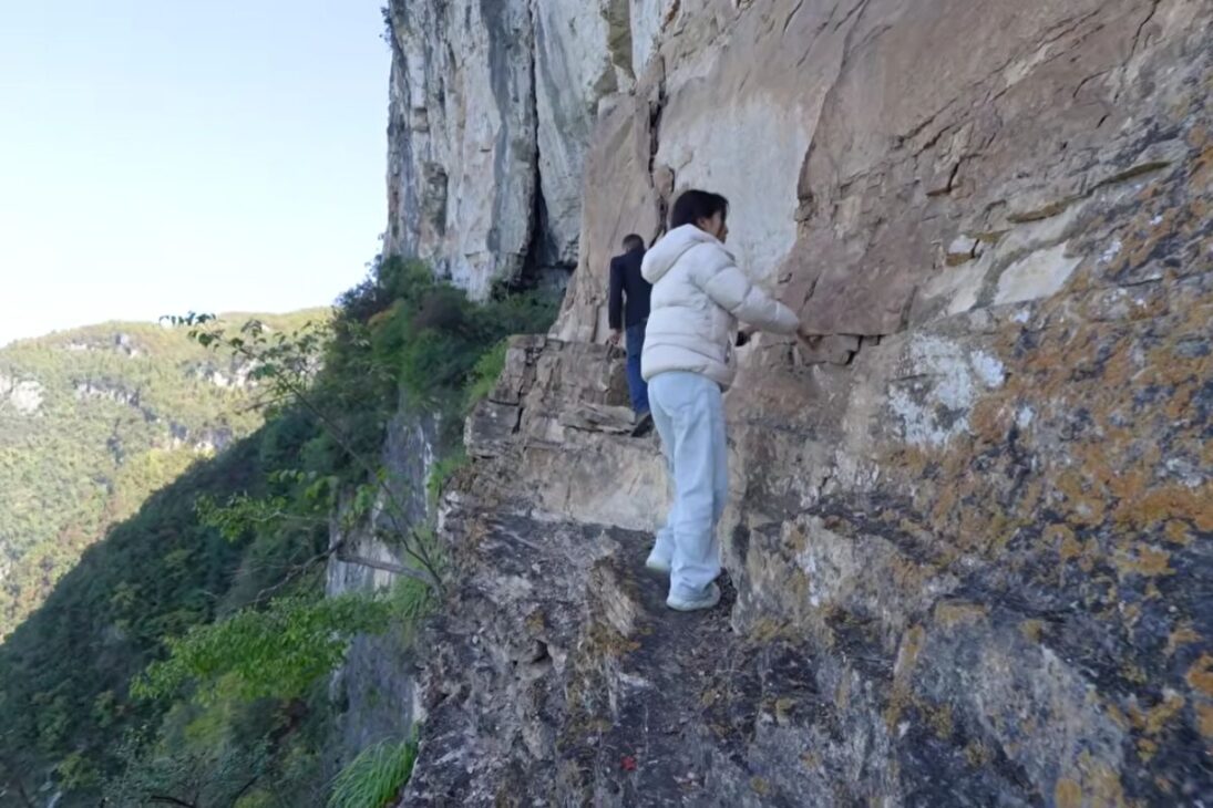 man in China opens a five kilometer scenic trail on a cliff and transforms an isolated landscape with manual labor.