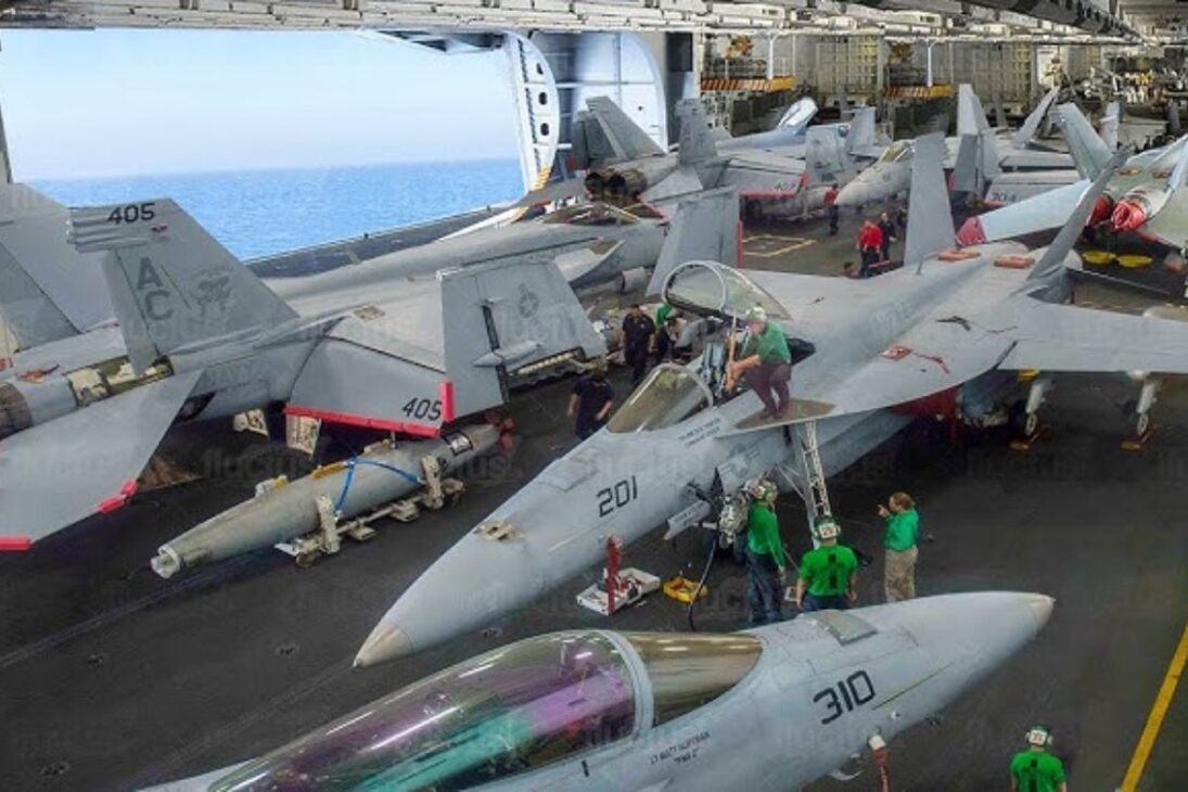 Aircraft carrier faces storm with jets secured on the deck and part sheltered in the hangar, where a single poorly secured link can turn billions into immediate loss in the ocean.