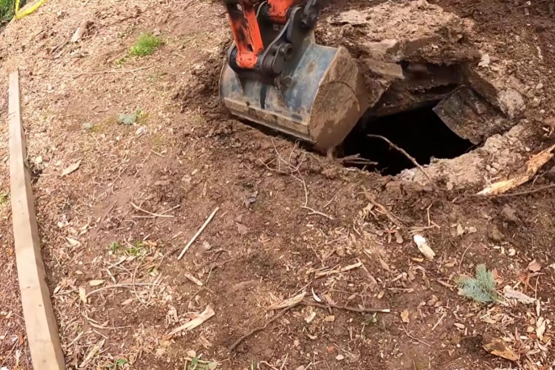 A strange hole reveals an underground concrete structure, raises suspicion of hidden bunker, and was ultimately identified as a septic tank.