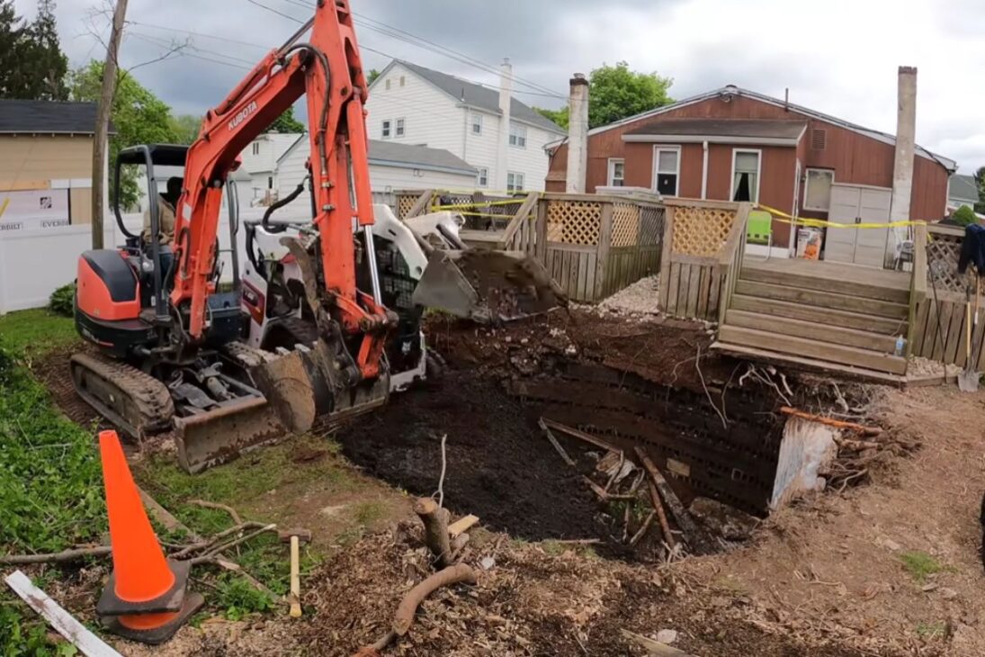 A strange hole reveals an underground concrete structure, raises suspicion of hidden bunker, and was ultimately identified as a septic tank.