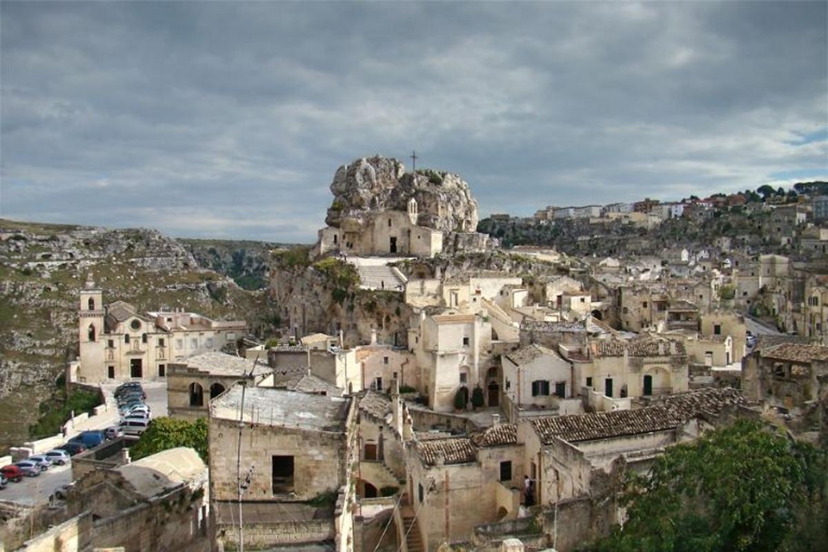 Vista panorâmica de Matera, na região da Basilicata, Itália, mostrando casas históricas esculpidas na rocha calcária do complexo Sassi di Matera, patrimônio mundial da UNESCO.